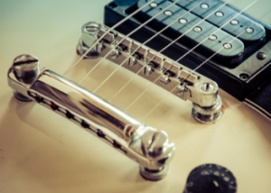An adjustable bridge system on an electric guitar