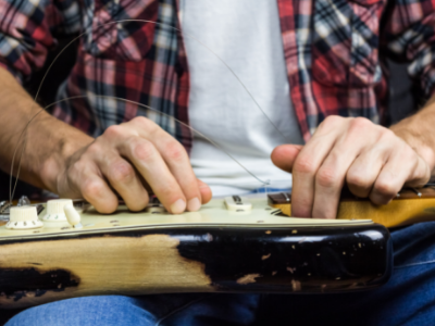 A guitar technician working on an instrument