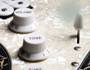 Volume and tone knobs and rocker switch to the right
