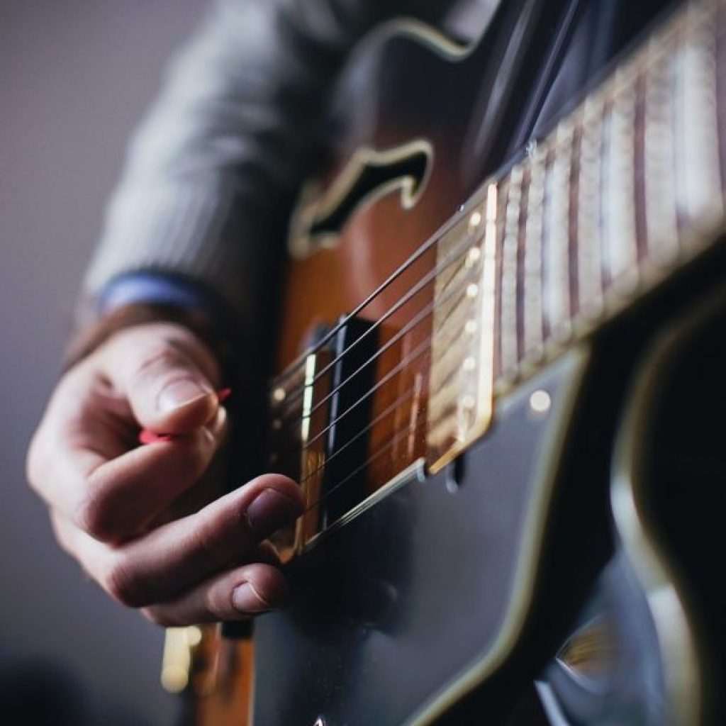Hand showing playing an electric guitar