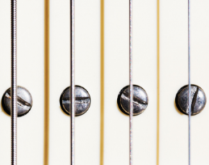Adjustable pickup screws on an electric guitar