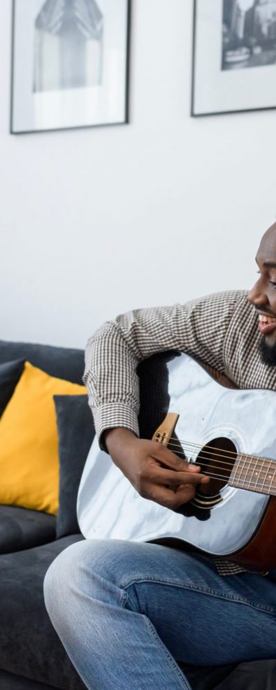 African American male musician playing guitar