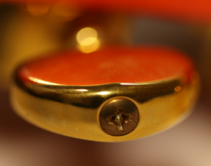 End view of a tuner with adjustable tension screw