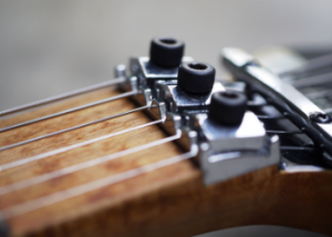 An adjustable nut on an electric guitar