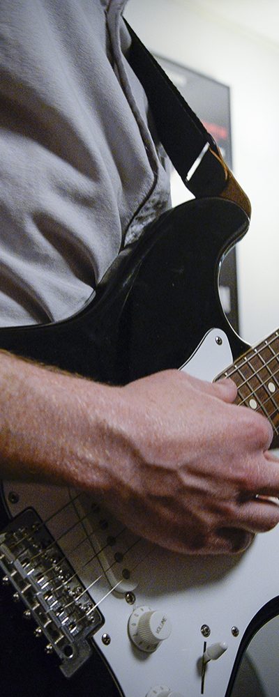 guitar guy playing white electric guitar rockband
