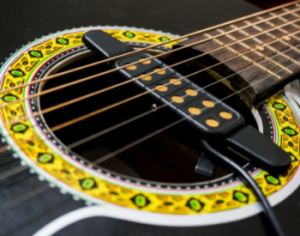 A removable pickup for an acoustic guitar