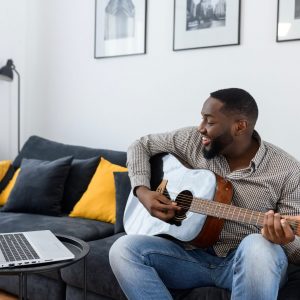 African American male musician playing guitar