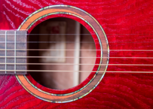 The sound hole of an acoustic guitar