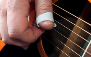 Guitarist Using a Thumb Pick